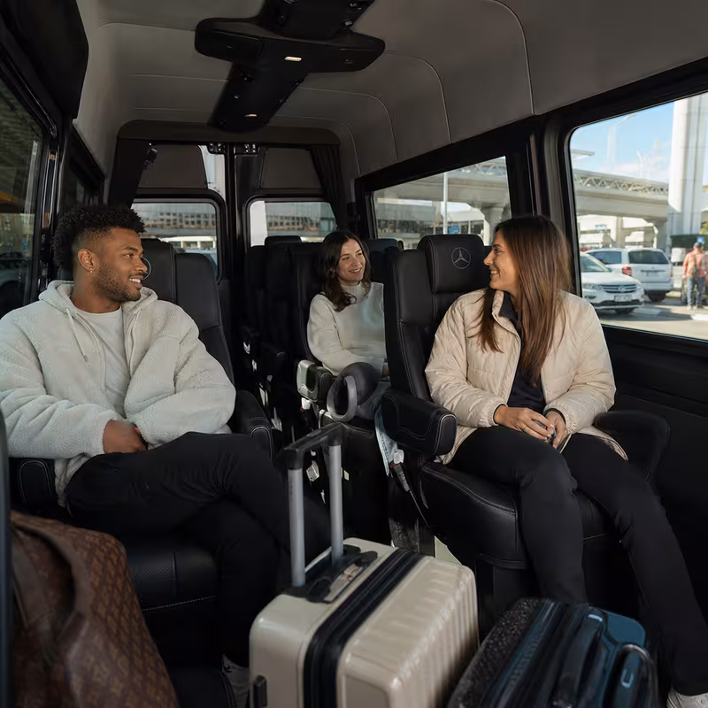 Passengers loading luggage while boarding an Los Angeles group shuttle