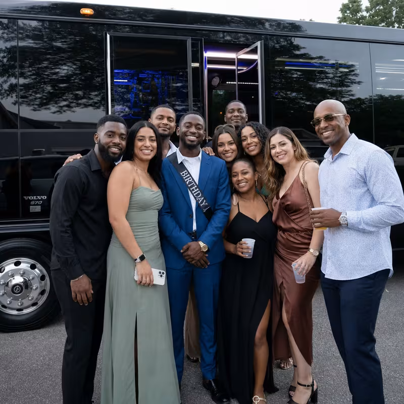 Group boarding a white charter bus for Birthday Transportation transportation in Los Angeles
