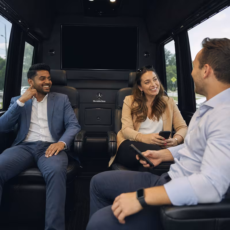 Group boarding a white charter bus for Corporate Transportation transportation in Los Angeles