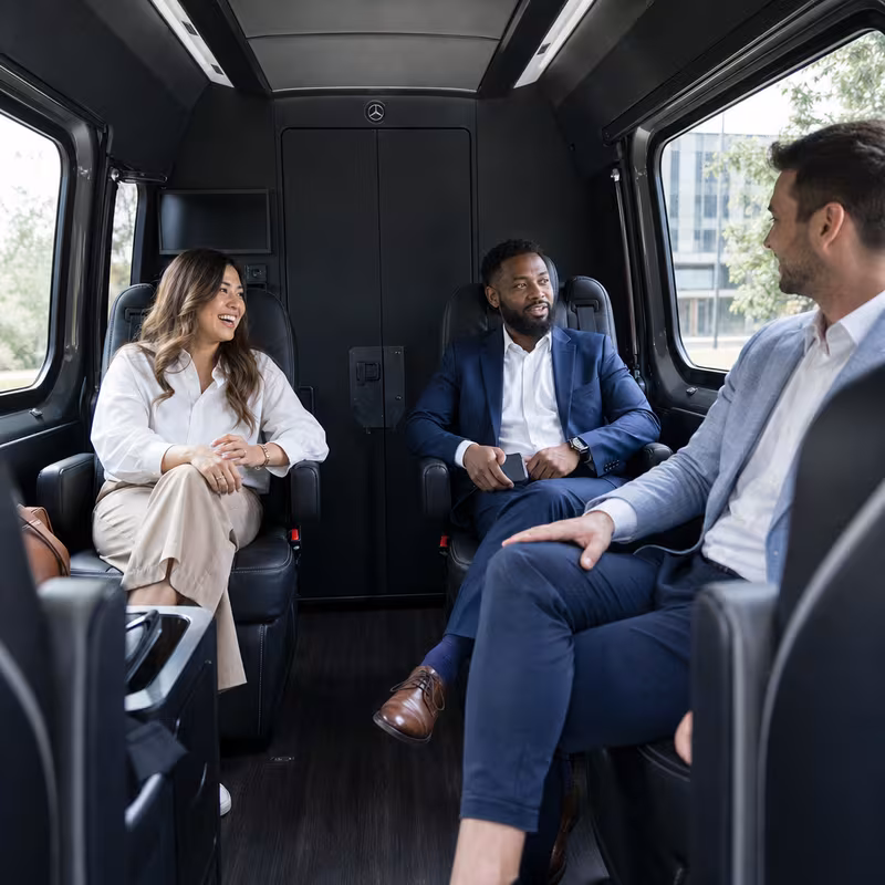 Passengers loading luggage while boarding an Los Angeles group shuttle