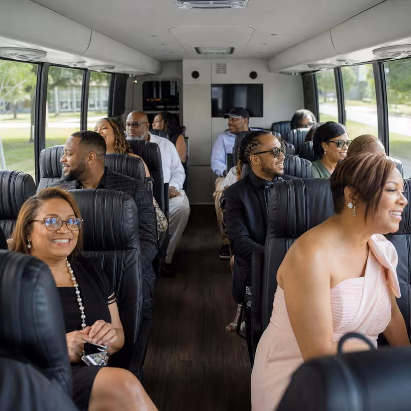 Group boarding a white charter bus for Private Event Transportation transportation in Los Angeles