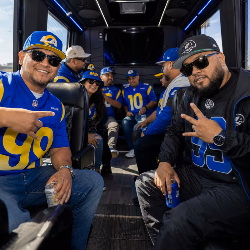 Group boarding a white charter bus for Sporting Event Transportation transportation in Los Angeles