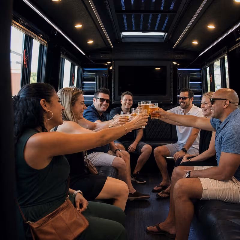 Group boarding a white charter bus for Winery & Brewery Tour Transportation transportation in Los Angeles